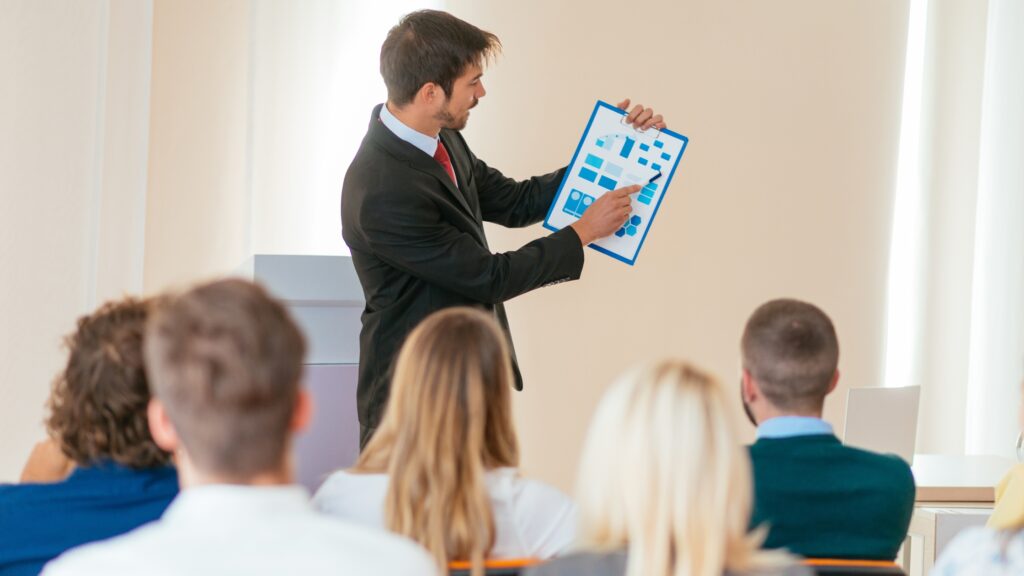 Office employee holding a folder and glasses, looking confident.