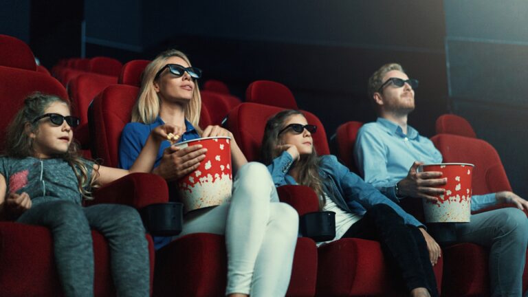 Viewers watching movie in a theater setting