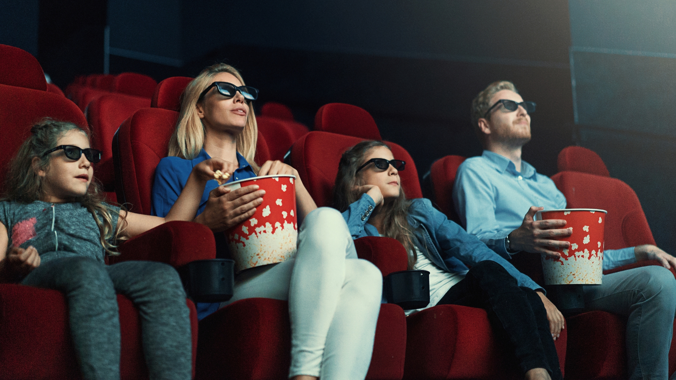 Viewers watching movie in a theater setting