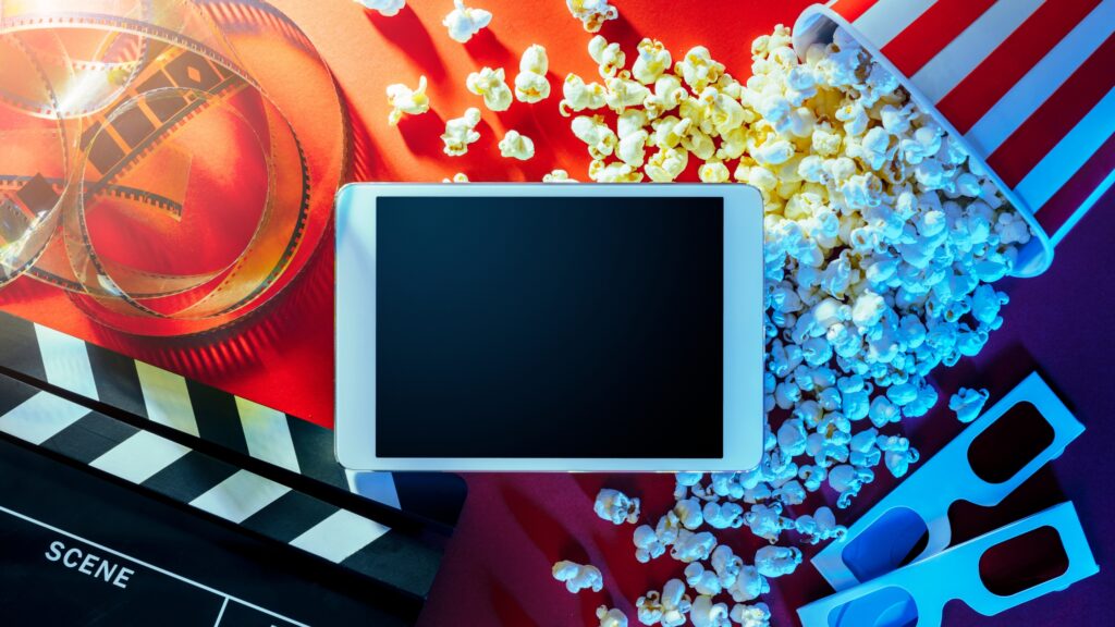 Popcorn, ticket, and screen — a classic movie-watching experience.