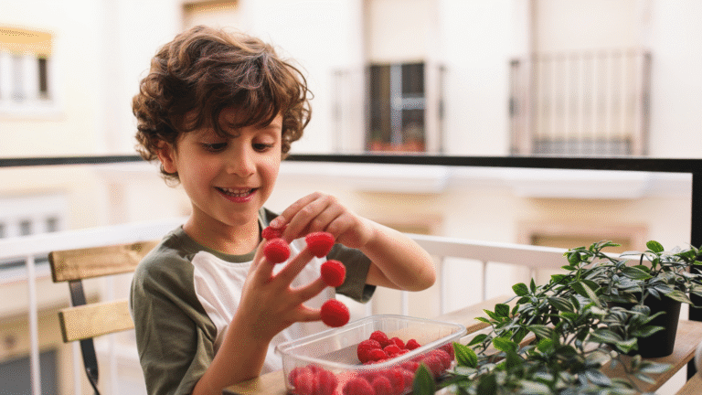 A kid smiling with strawberries