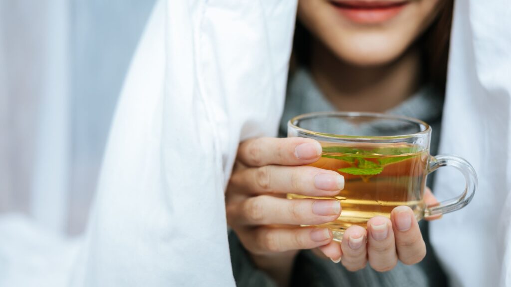 a girl enjoying her lemon her lemon tea